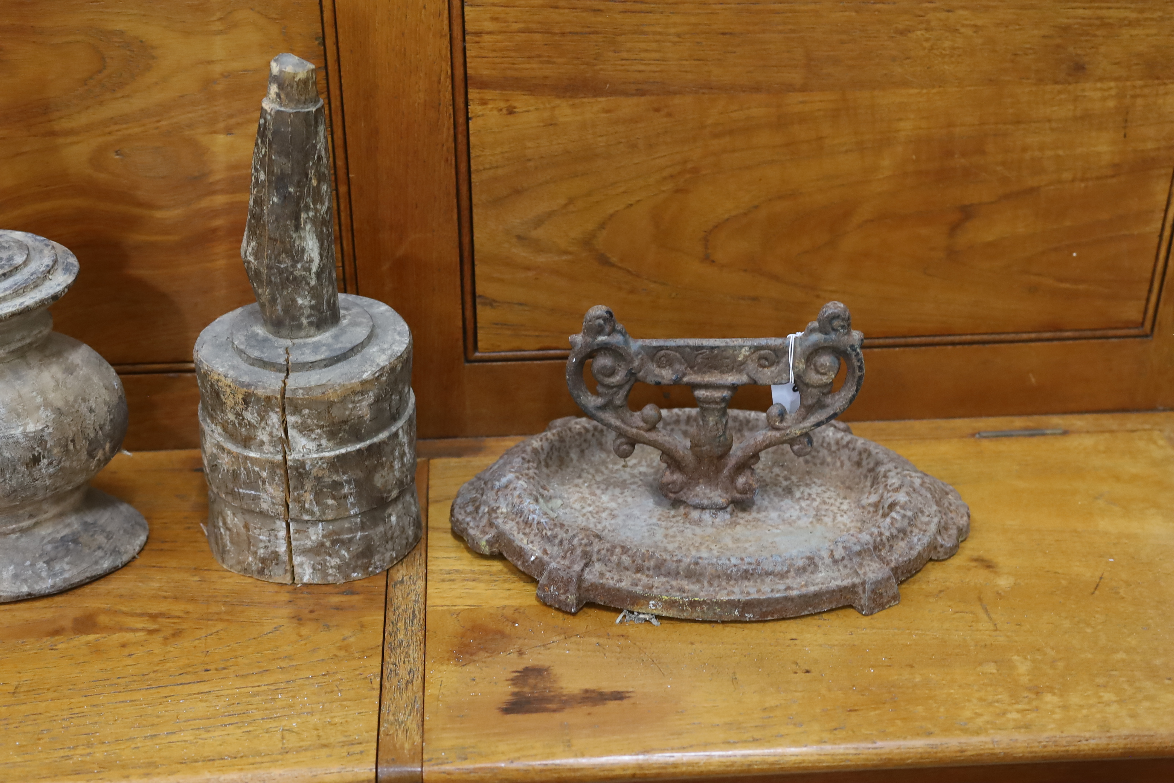 A Victorian cast iron boot scraper and three African wood mallets